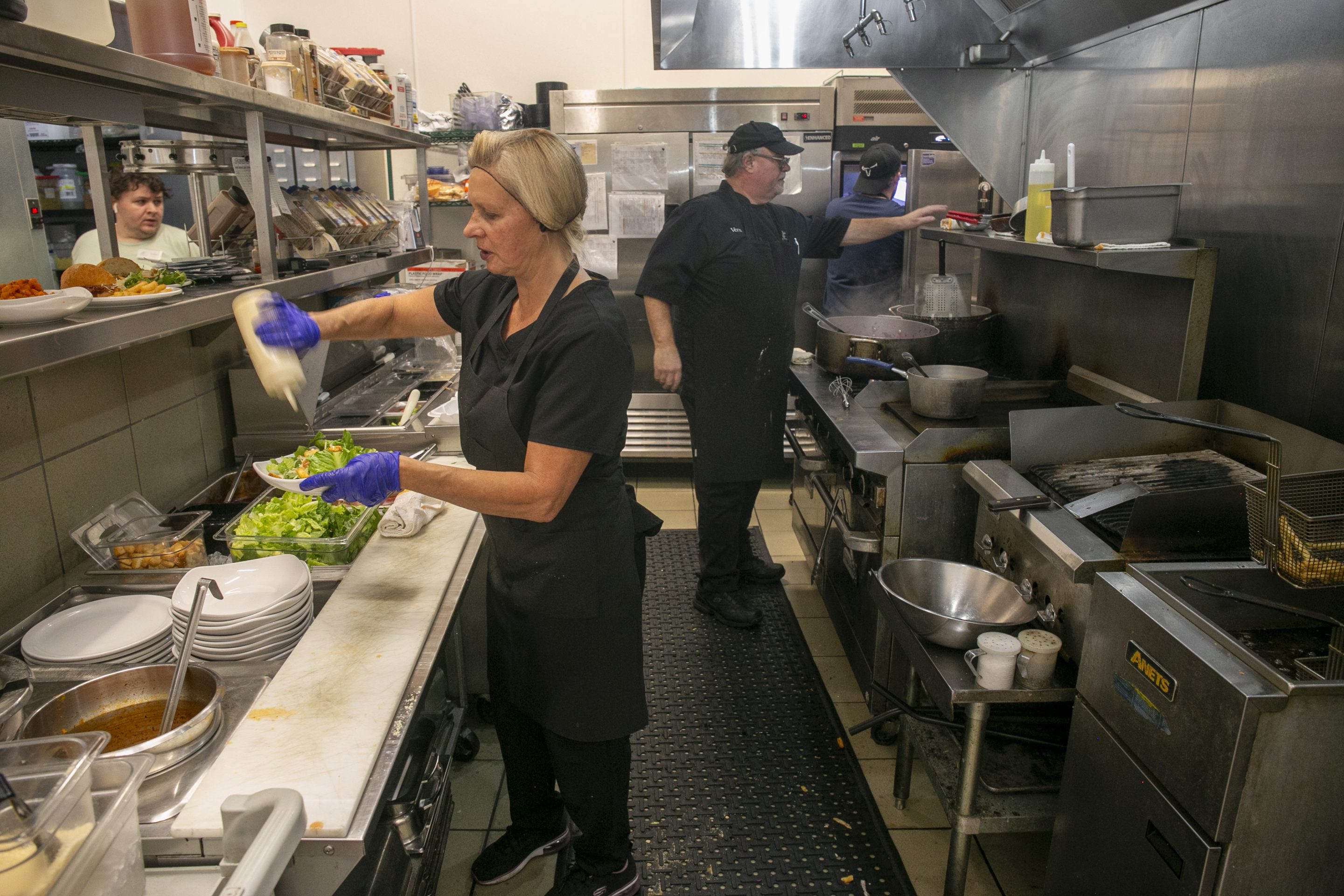 A Group Of People In A Kitchen